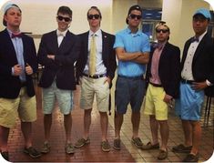 four men in suits and ties are posing for a photo with one man wearing sunglasses