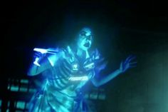 a female soccer player in the dark with her mouth open and lights on behind her