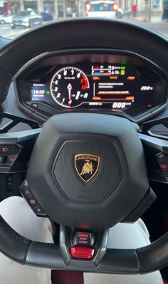 the steering wheel and dashboard of a sports car