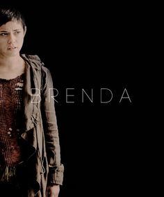 a woman standing in front of a black background with the words brenda written on it