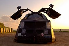 an unusual vehicle is parked in the dirt