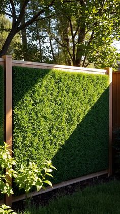 a wooden fence covered in green grass