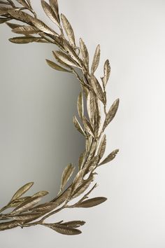 a mirror that has some gold leaves on it