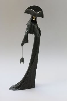 a statue of a woman holding an umbrella