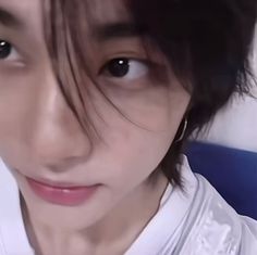 a close up of a person wearing a white shirt and bow tie with black hair