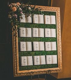 an old framed book display is decorated with flowers and greenery for a wedding ceremony