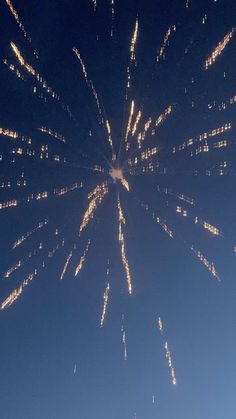 fireworks are lit up in the night sky with bright lights on it's sides
