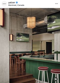an image of a restaurant setting with bar stools and green counter top in the foreground