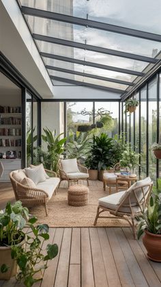 a room filled with lots of plants and furniture