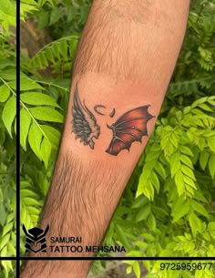 a man with a dragon tattoo on his arm next to some plants and trees in the background