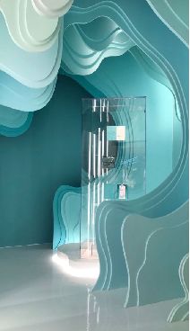 an artisticly designed room with blue and white waves painted on the walls, along with a glass display case
