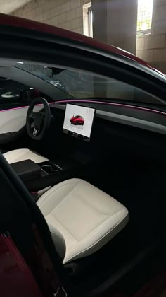 the interior of a car with white leather seats and pink trimmings on it