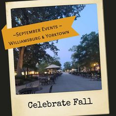 an outdoor event with tables and umbrellas on the side walk at night, surrounded by trees