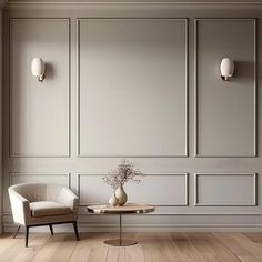 an empty room with two chairs and a table in the middle, there is a vase with flowers on it