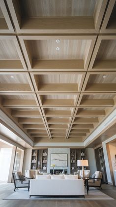 a living room with wooden ceilings and white furniture