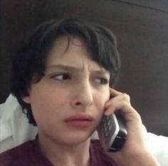 a close up of a person talking on a cell phone