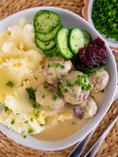a plate with mashed potatoes, cucumbers and cranberry sauce on it