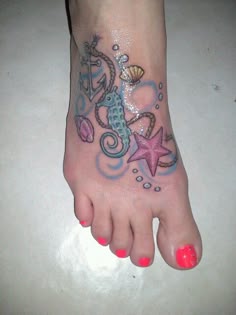 a foot with a seahorse and starfish tattoo on it's left side