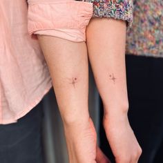 two people with small tattoos on their legs