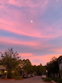 the sky is pink and blue as the sun sets