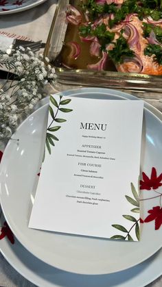 a plate with a menu sitting on top of it next to other plates and utensils