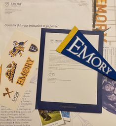 an envelope with some stickers on top of it next to other papers and magnets