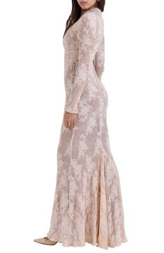 Delicate floral lace romances a gauzy figure-skimming gown designed with a slender waist sash for definition and a flowy scallop-trimmed hem for subtle movement. Exclusive retailer Jewel neck Long sleeves Lined 100% polyester Dry clean Imported Fitted Lace Maxi Dress With Lace Sleeves, Formal Long-sleeve Lace Maxi Dress, Long Sleeve Lace Gown With Lace Trim, Long Sleeve Lace Maxi Dress With Lace Trim, House Of Cb Mahalia, House Of Cb Gaia Dress, House Of Cb Mahalia Dress, Beige Long Sleeve Maxi Dress With Lace Trim, House Of Cb Long Sleeve Dress