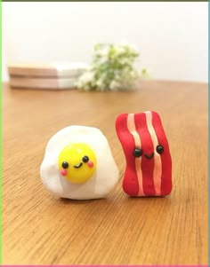 two small toy eggs sitting next to each other on a table