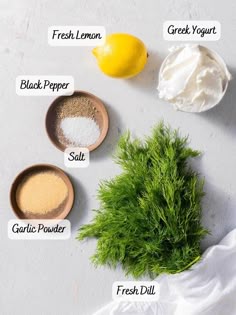 the ingredients to make lemon dill dip on a white surface with text overlay