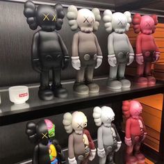 many different colored toy figures on display in a store or office building, some with faces and ears