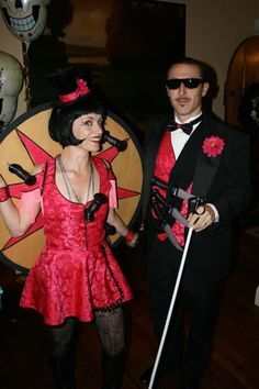 a man and woman dressed in costumes standing next to each other