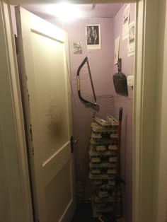 a room with a bunch of boxes on the floor and a vacuum in the hallway