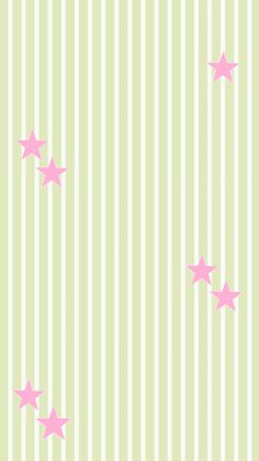 some pink stars are flying in the air on a green and white striped wallpaper