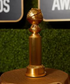 a golden trophy sitting on top of a table