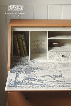 an old dresser has been painted white with blue and gray designs on the top shelf