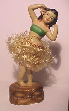a figurine of a woman in a hula skirt