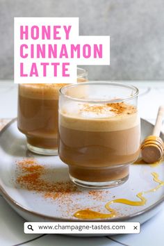 two glasses of honey cinnamon latte on a plate with the words, honey cinnamon latte