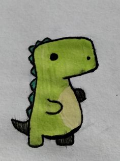 a drawing of a green dinosaur on white paper