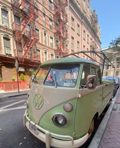 an old vw bus is parked on the side of the street