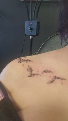 a woman with a bat tattoo on her back
