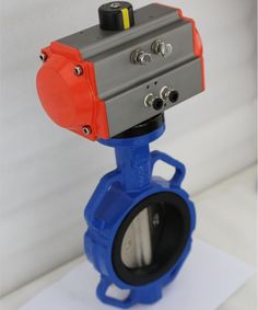 a blue and red ball valve sitting on top of a piece of paper with a white background