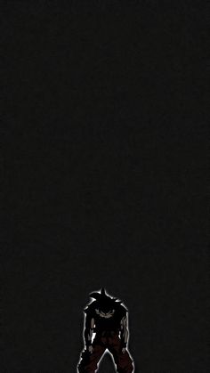 the silhouette of a person standing in front of a dark background