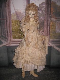a doll is standing in front of a window wearing a dress with ruffles