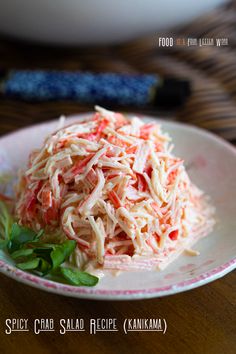 a white plate topped with coleslaw salad on top of a wooden table