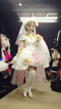 a woman in a wedding dress standing on a runway