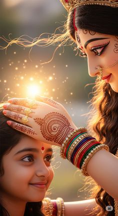 two beautiful women with henna on their hands, one is touching the other's forehead