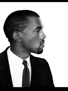 a black and white photo of a man in a suit looking off to the side