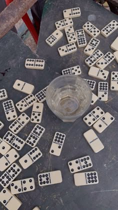 dominos laid out on the ground in front of a glass bowl with one missing