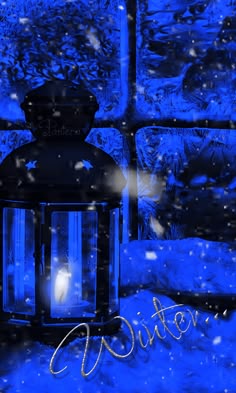 a blue lantern sitting in the snow next to a window with words written on it