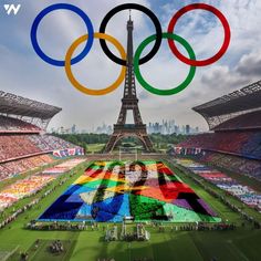 the olympic flag is displayed in front of the eiffel tower